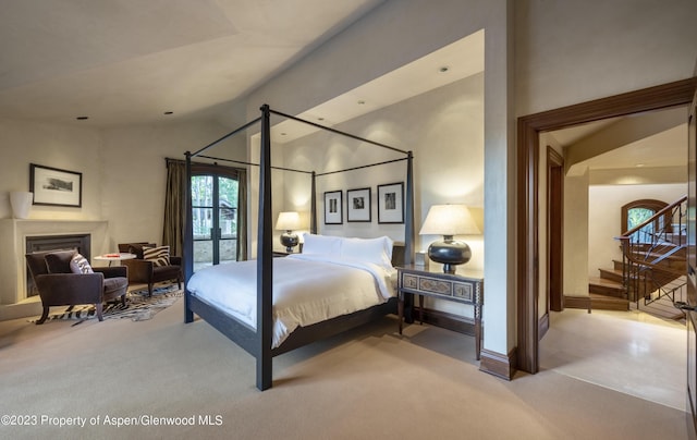 carpeted bedroom featuring lofted ceiling