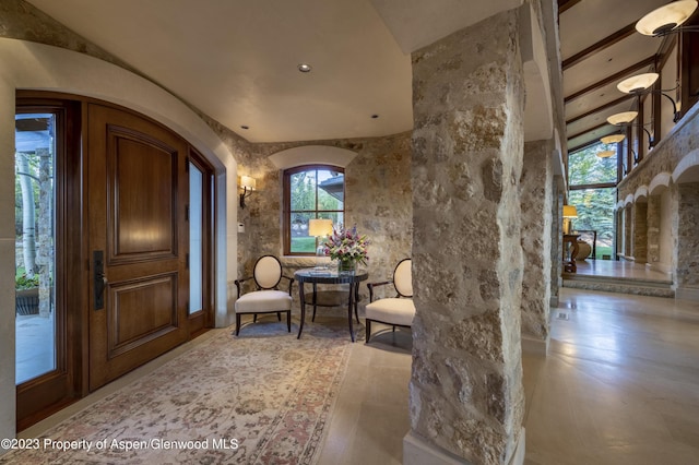 foyer entrance with beamed ceiling