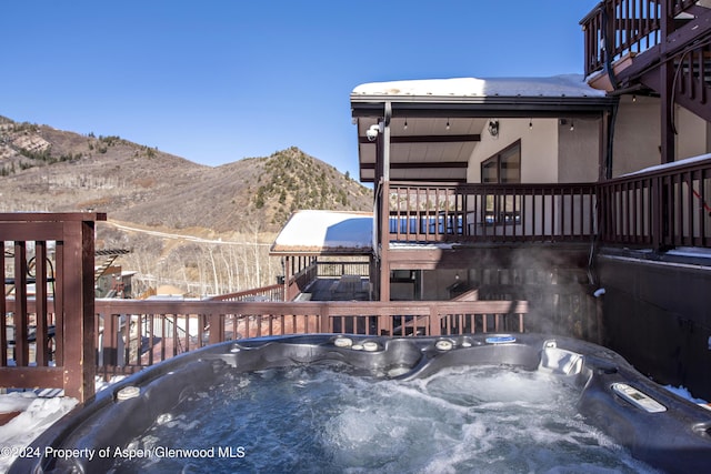 wooden terrace with a mountain view and a hot tub