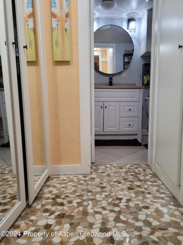 bathroom with tile patterned flooring and vanity