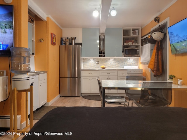 kitchen featuring appliances with stainless steel finishes, backsplash, light hardwood / wood-style floors, and white cabinetry