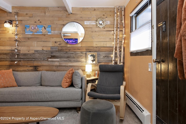 interior space featuring beam ceiling, baseboard heating, and wood walls