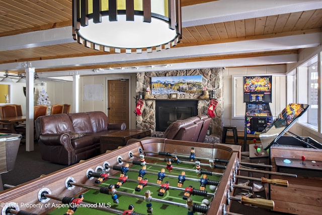 recreation room with a fireplace, beam ceiling, and wooden ceiling