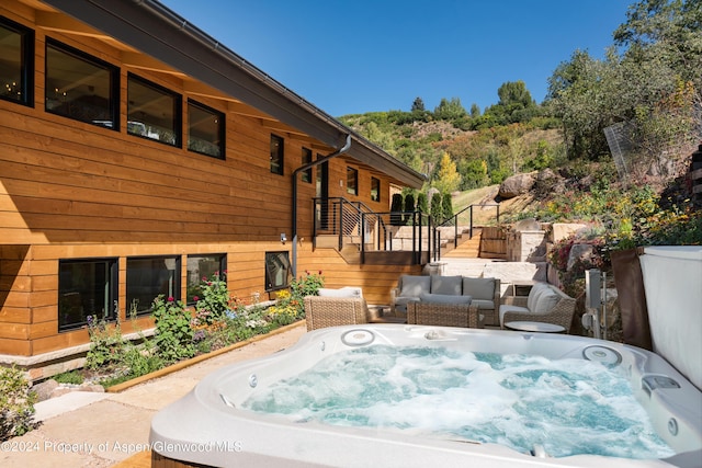deck featuring stairway and a hot tub