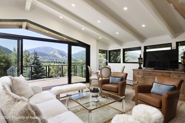 living room featuring lofted ceiling with beams, baseboard heating, recessed lighting, and a mountain view
