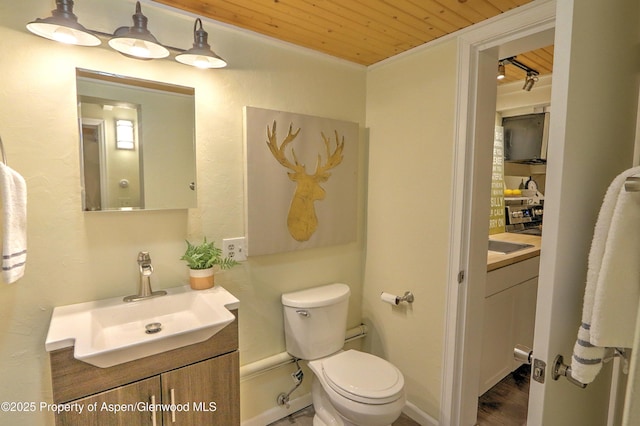 11101 County Road 117 Unit 3D, Glenwood Springs, CO 81601 - bathroom featuring wood ceiling, vanity, toilet, and wood finished floors