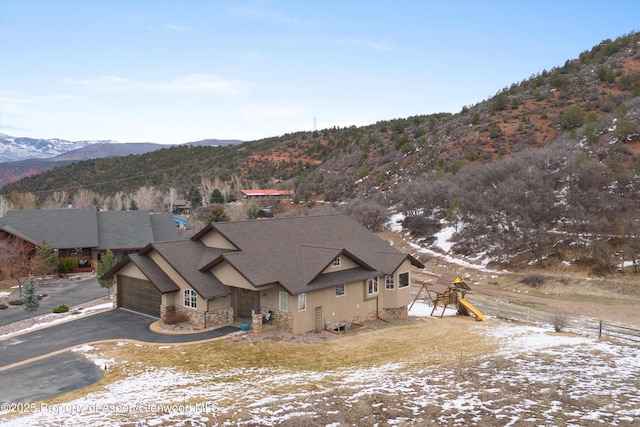 13 Laird Ln, Glenwood Springs, CO 81601 - view of front of home featuring a mountain view, stone siding, a shingled roof, and an attached garage