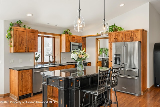 13 Laird Ln, Glenwood Springs, CO 81601 - kitchen featuring appliances with stainless steel finishes, a sink, a kitchen island, wood finished floors, and recessed lighting