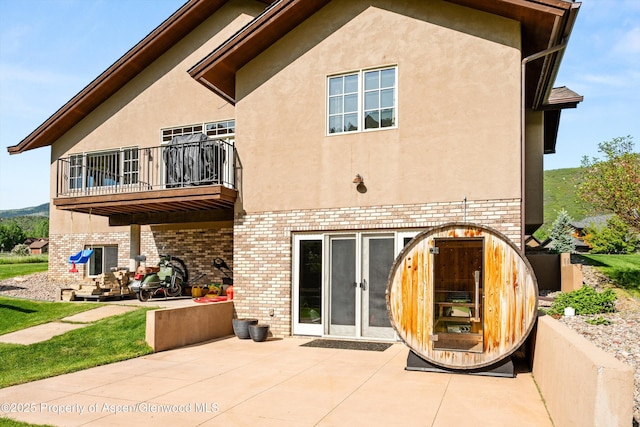 13 Laird Ln, Glenwood Springs, CO 81601 - rear view of house with a balcony, a patio area, stucco siding, and brick siding