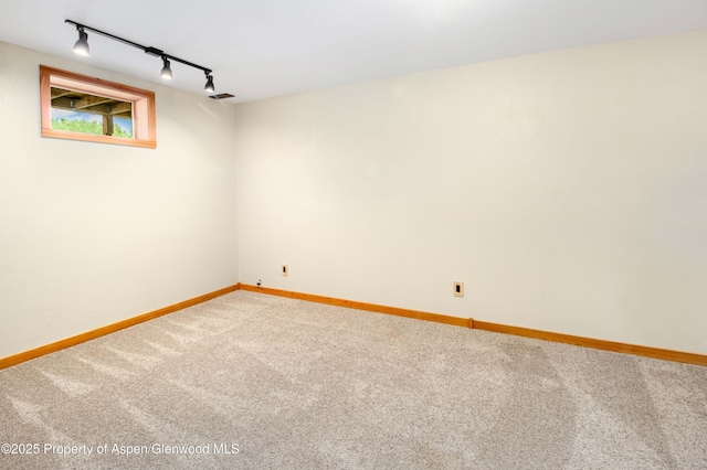 456 County Road 294, Rifle, CO 81650 - carpeted empty room featuring rail lighting and baseboards