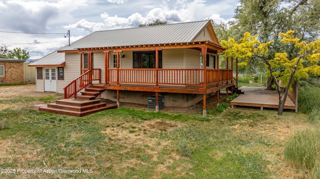 456 County Road 294, Rifle, CO 81650 - rear view of property with a yard, metal roof, and a deck