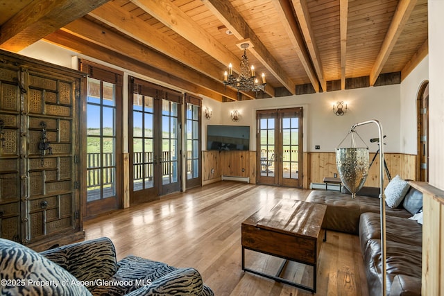 200 Forest Dr, Carbondale, CO 81623 - living area featuring french doors, wooden ceiling with exposed beams, wainscoting, a chandelier, and a baseboard heating unit