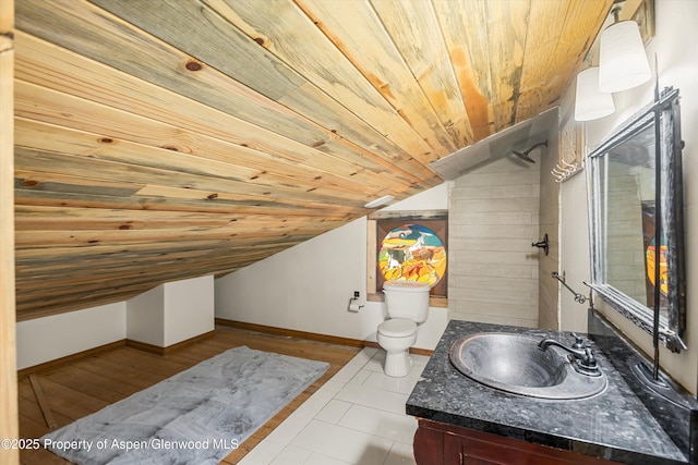 200 Forest Dr, Carbondale, CO 81623 - bathroom with vaulted ceiling, wood ceiling, vanity, toilet, and baseboards
