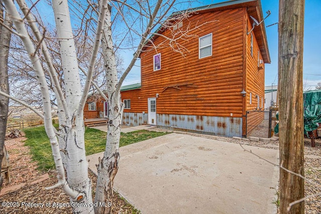 1020 Thompson Way, Craig, CO 81625 - view of side of property with a patio and log veneer siding