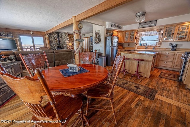 1020 Thompson Way, Craig, CO 81625 - dining area with visible vents, beam ceiling, a textured ceiling, and dark wood-type flooring