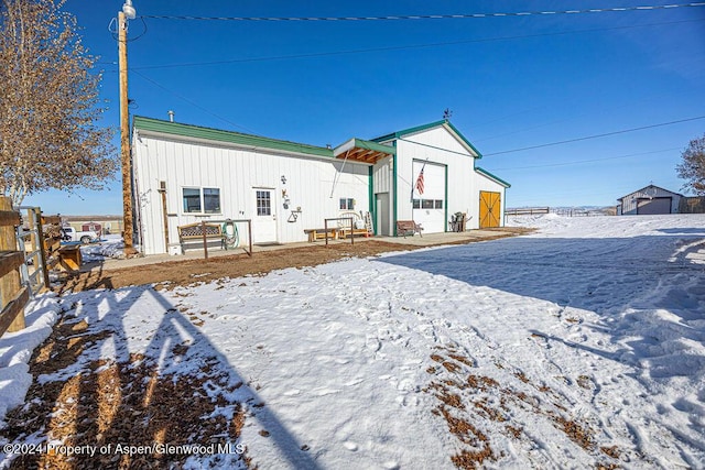 1020 Thompson Way, Craig, CO 81625 - snow covered house with fence, an outbuilding, and board and batten siding