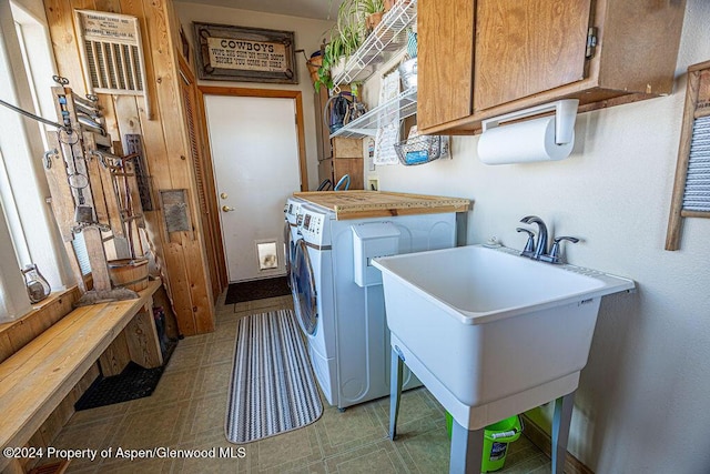 1020 Thompson Way, Craig, CO 81625 - washroom featuring cabinet space, tile patterned floors, washing machine and dryer, and a sink