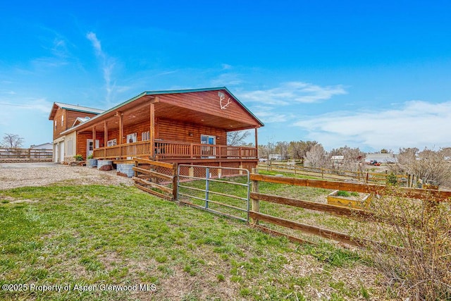 1020 Thompson Way, Craig, CO 81625 - view of side of property with covered porch, log veneer siding, a lawn, a garage, and fence