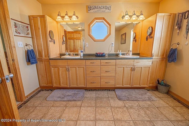 1020 Thompson Way, Craig, CO 81625 - full bath featuring a sink, baseboards, and double vanity