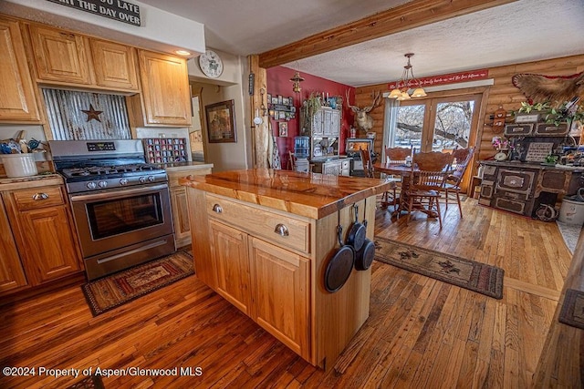 1020 Thompson Way, Craig, CO 81625 - kitchen featuring stainless steel gas range, butcher block countertops, beam ceiling, and hardwood / wood-style flooring