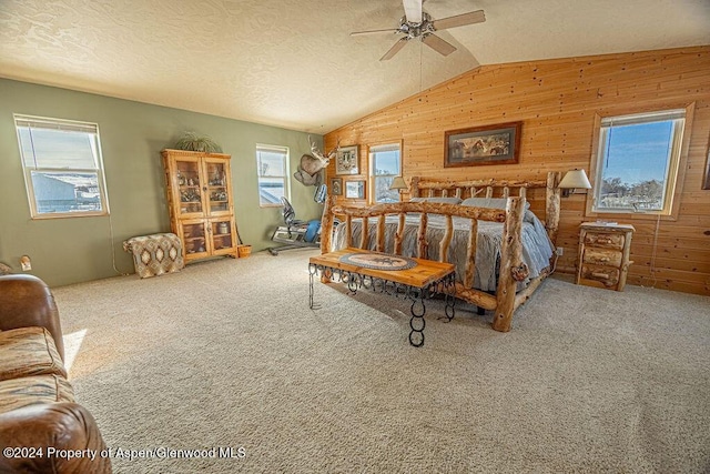 1020 Thompson Way, Craig, CO 81625 - carpeted bedroom with a ceiling fan, wood walls, and vaulted ceiling
