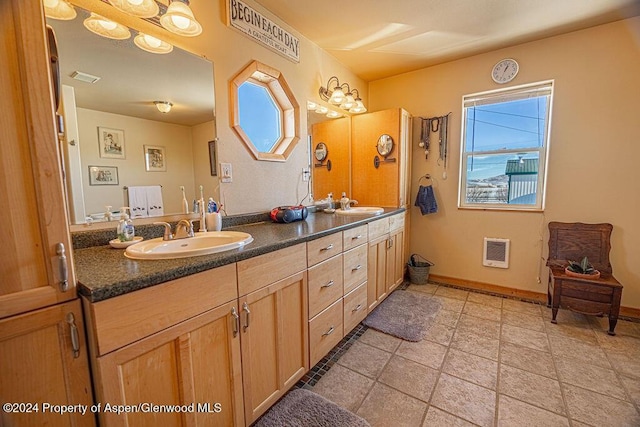 1020 Thompson Way, Craig, CO 81625 - full bathroom with double vanity, baseboards, heating unit, and a sink