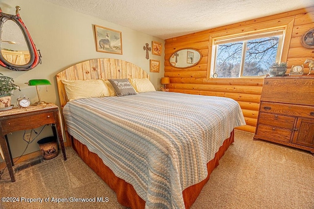 1020 Thompson Way, Craig, CO 81625 - carpeted bedroom featuring a textured ceiling and log walls