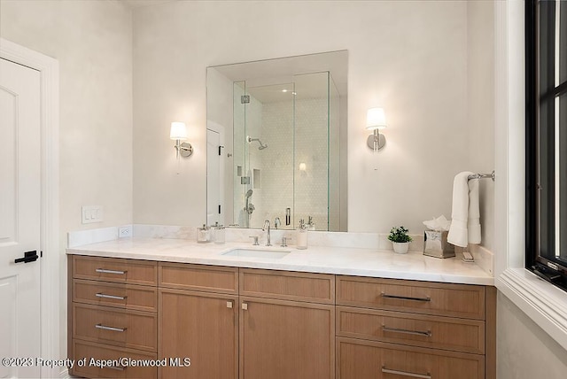 bathroom featuring vanity and a shower with shower door