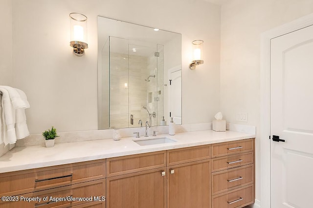 bathroom featuring vanity and a shower with door