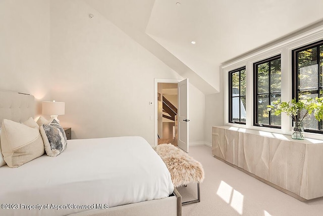 carpeted bedroom featuring lofted ceiling