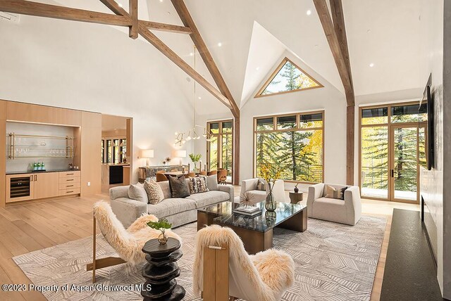 living room with beamed ceiling, high vaulted ceiling, a healthy amount of sunlight, and wine cooler