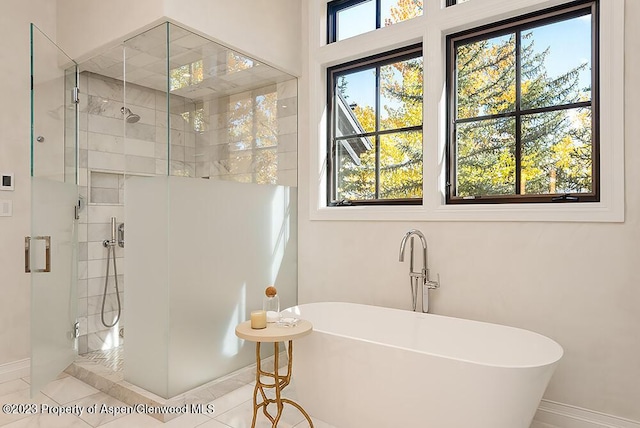 bathroom with tile patterned floors, plenty of natural light, and shower with separate bathtub