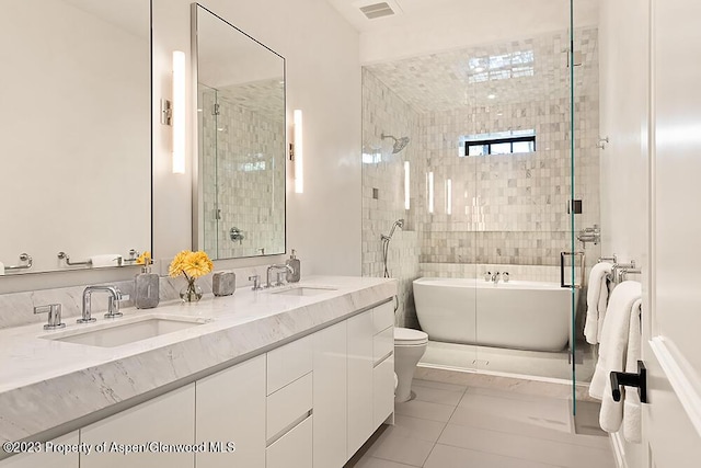 bathroom with tile patterned floors, vanity, and shower with separate bathtub