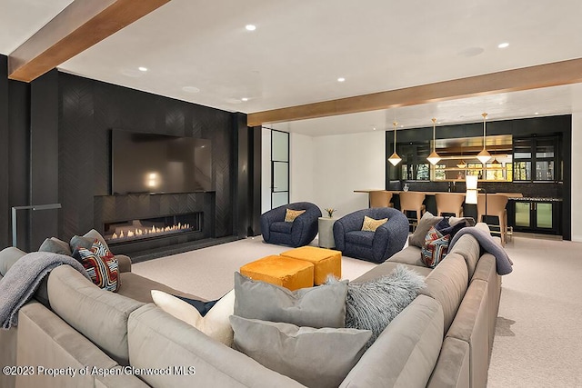 living room with beam ceiling, a fireplace, and carpet