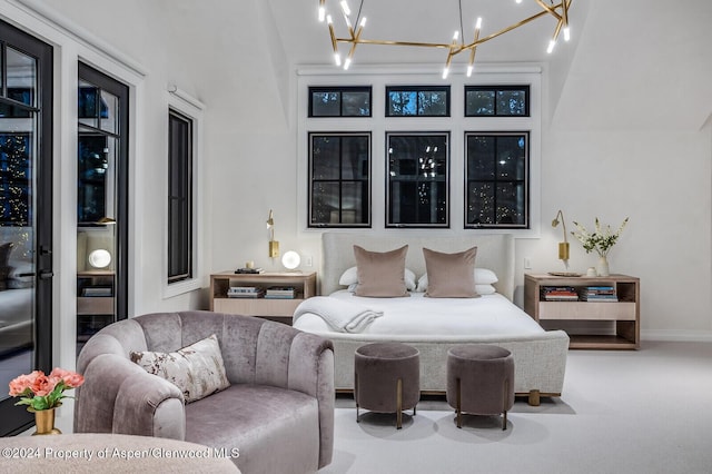 bedroom with access to outside and a notable chandelier