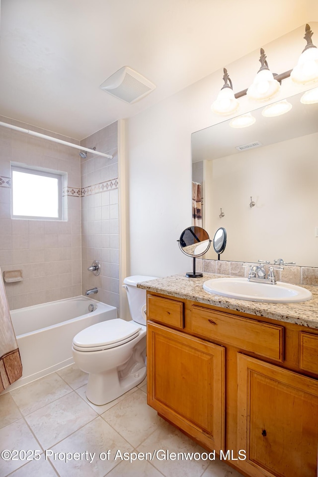 full bathroom featuring shower / tub combo with curtain, tile patterned floors, toilet, and vanity