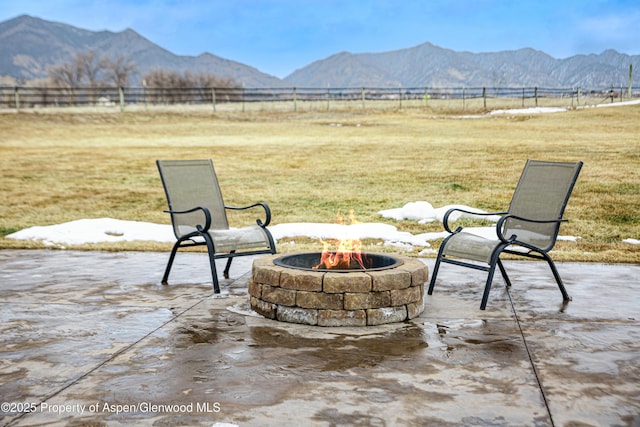 view of patio / terrace featuring a mountain view, a rural view, and an outdoor fire pit