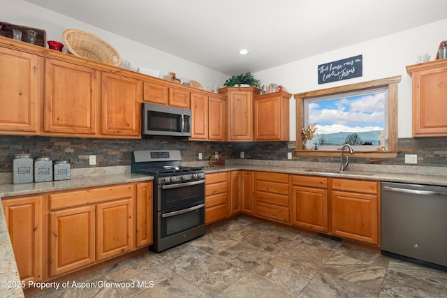 kitchen with appliances with stainless steel finishes, sink, and decorative backsplash