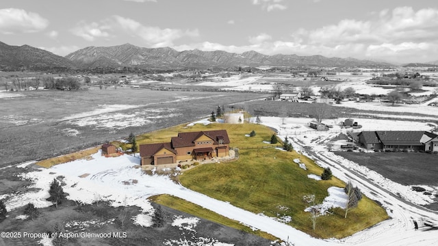 snowy aerial view with a mountain view