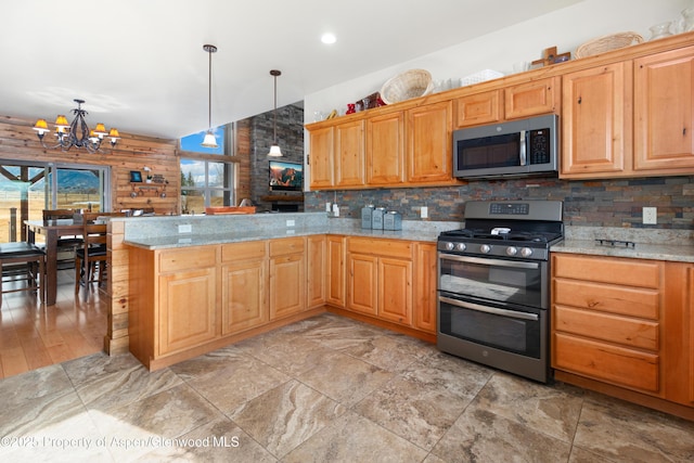 kitchen featuring stainless steel appliances, decorative light fixtures, kitchen peninsula, and log walls