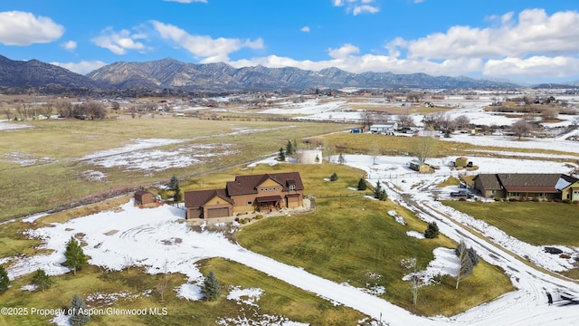 snowy aerial view with a mountain view