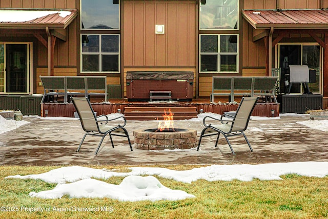 view of patio featuring a fire pit and a hot tub