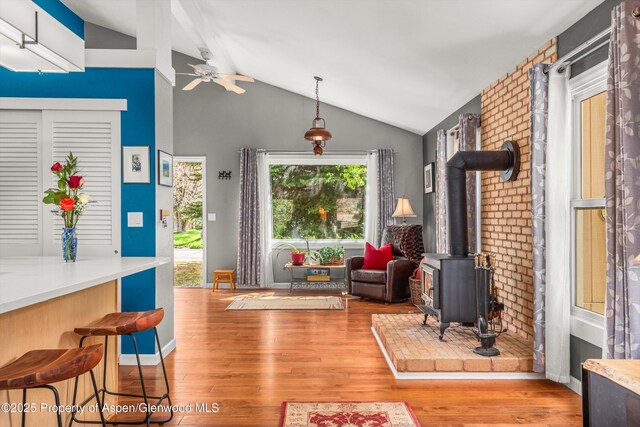 191 Navajo, Carbondale, CO 81623 - living room with vaulted ceiling, a wood stove, ceiling fan, and wood finished floors