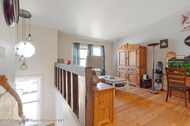 interior space featuring light wood finished floors and an upstairs landing