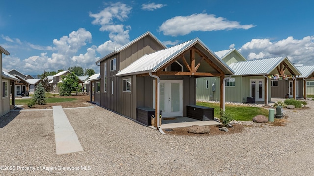 329 River Frontage Rd # 65, Silt, CO 81652 - view of front of home with french doors, board and batten siding, a metal roof, and a residential view