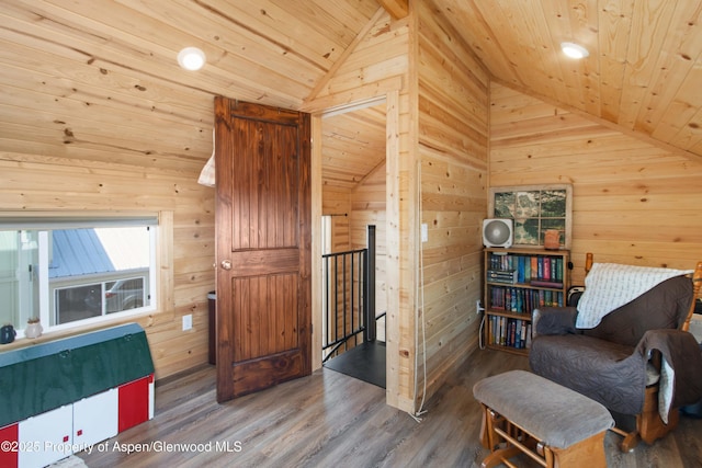 329 River Frontage Rd # 65, Silt, CO 81652 - living area with an upstairs landing, lofted ceiling, wood walls, wooden ceiling, and wood finished floors