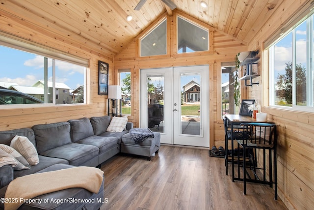 329 River Frontage Rd # 65, Silt, CO 81652 - living room with lofted ceiling, wooden walls, plenty of natural light, wood finished floors, and french doors