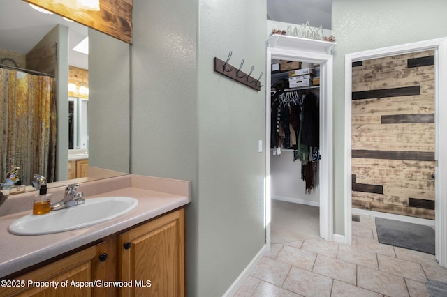 bathroom with a shower with curtain, tile patterned floors, and vanity