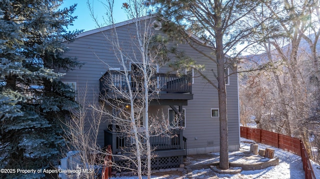 view of snow covered exterior featuring a balcony