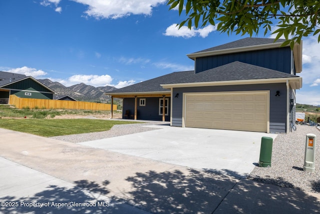 1720 Belgian Loop, Silt, CO 81652 - view of front of property with board and batten siding, driveway, a mountain view, a garage, and a porch
